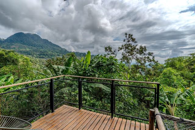 A room deck looking out at the mountains under dramatic clouds