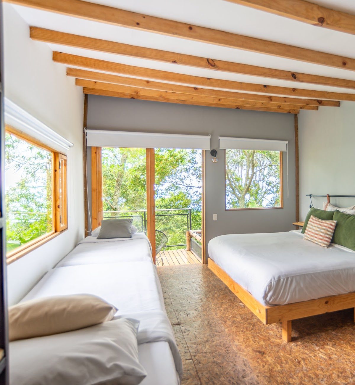 Inside the shared room, beds looking out to the balcony