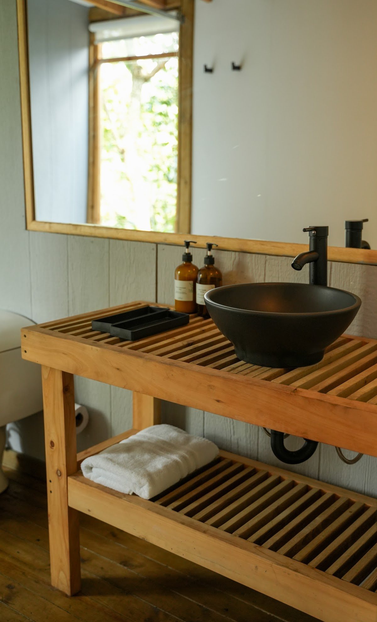 The bathroom's wooden vanity and sink
